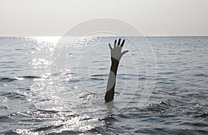 hand of man on the water of ocean