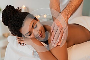 Arm massage for African American woman in a tranquil spa