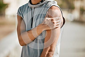 Arm, mockup and man in street with injury or ache in fitness, sports or cardio on blurred background. Shoulder pain