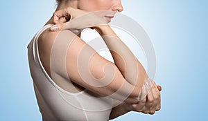 Arm pain and injury concept. Closeup side profile woman with painful elbow photo