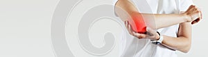 Arm pain and injury for woman. Closeup side body with painful elbow  on beige background