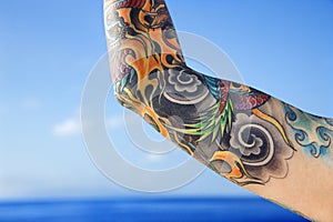 Arm of tattooed woman.