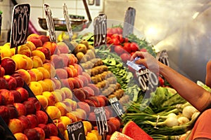 Arm of woman paying purchase on food market