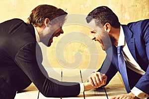 Arm wrestling of businessman and aggressively compete man