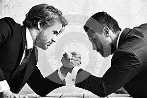 Arm wrestling of businessman and compete man