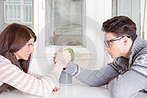 Arm wrestling challenge between a young couple