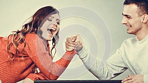 Arm wrestling challenge between young couple