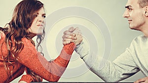 Arm wrestling challenge between young couple