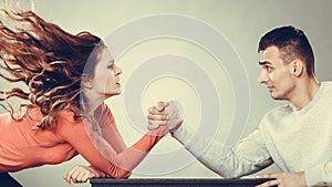 Arm wrestling challenge between young couple