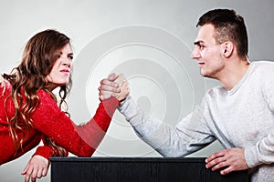 Arm wrestling challenge between young couple