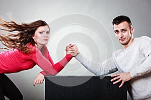 Arm wrestling challenge between young couple