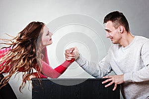 Arm wrestling challenge between young couple