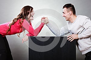 Arm wrestling challenge between young couple