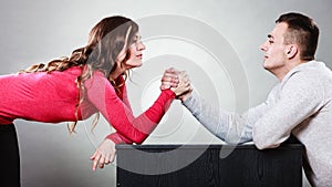 Arm wrestling challenge between young couple