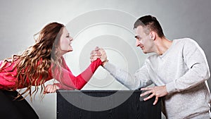 Arm wrestling challenge between young couple