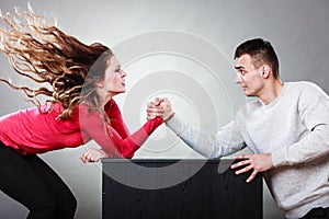 Arm wrestling challenge between young couple