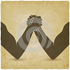 Arm wrestling. Two men hands shaking silhouette vintage background