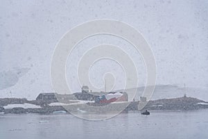 Armada De Chile Base, Gonzales Videla research station, view from the water on a snowy and foggy day, Paradise Bay, Antarctica