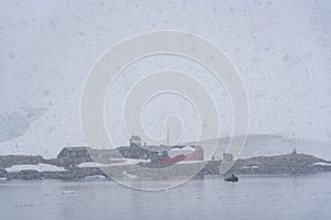 Armada De Chile Base, Gonzales Videla research station, view from the water on a snowy and foggy day, Paradise Bay, Antarctica photo