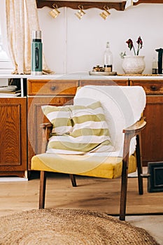 Armchair with pillow in the kitchen of countryside house, nobody