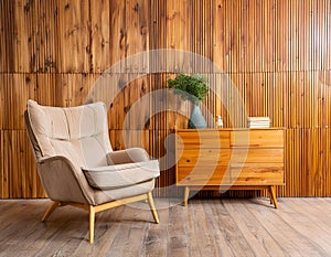 Armchair and wooden cabinet near wooden planks paneling wall. Loft interior design of modern