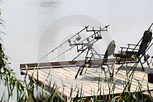 Armchairs with fishing tackle on pier