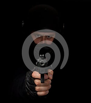 Armed assassin with motorcycle helmet aiming photo