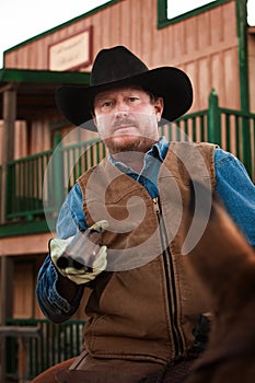 Armed Cowboy on Horseback