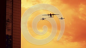 Armed russian fighter jets on the red sunset background