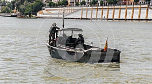 Armed soldiers aboard light boat during military operation in the city river
