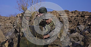 Armed soldiers looking at a computer