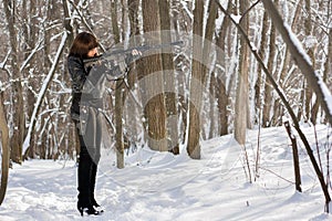 Armed woman in the forest