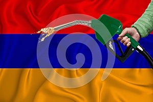 ARMENIA flag Close-up shot on waving background texture with Fuel pump nozzle in hand. The concept of design solutions. 3d