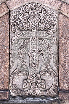 Armenian Christian cross carved in stone. Ancient ornamental christian cross on stone in church