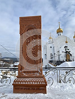 Armenian Khachkar in front of the temple of Seraphim of Sarov in the city of Zlatoust. Russia, Chelyabinsk region, Russia