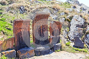 Armenian stone cross called khachkar on the territory of the ancient monastery of Sevanavark in Armenia