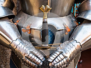 Armor of a medieval warrior holding a sword photo