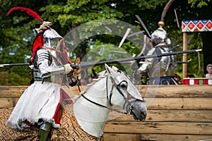 Armored knight on horseback charging in a joust