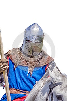 Armoured knight on white warhorse closeup photo