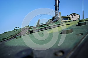 Armoured vehicle front green steel plating, close-up detail to small window with wiper