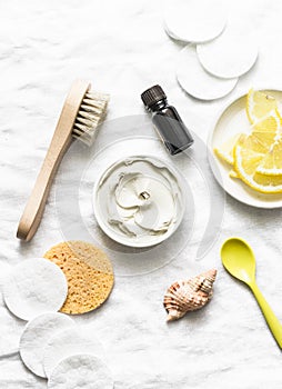 Armpit detox mask with white clay, tea tree essential oil and lemon on a light background