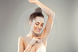 Armpit epilation, lacer hair removal. Young woman holding her arms up and showing clean underarms, depilation  smooth clear skin . photo