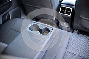 Armrest in the car with can holders, rear seats