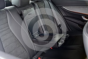 Armrest in the car with cup holder for rear seats row