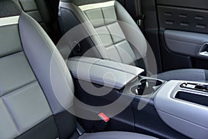 Armrest in the luxury passenger car between the front seats