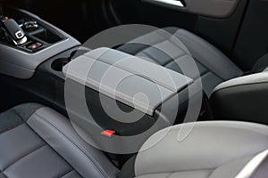 Armrest in the luxury passenger car between the front seats