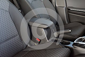 Armrest in the luxury passenger car between the front seats