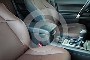 Armrest in the luxury passenger car between the front seats