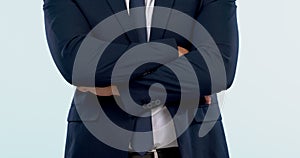 Arms crossed, suit and closeup of business man in studio isolated on a white background. Hands folded, confident