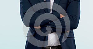 Arms crossed, suit and torso of business man in studio isolated on a white background. Hands folded, confident